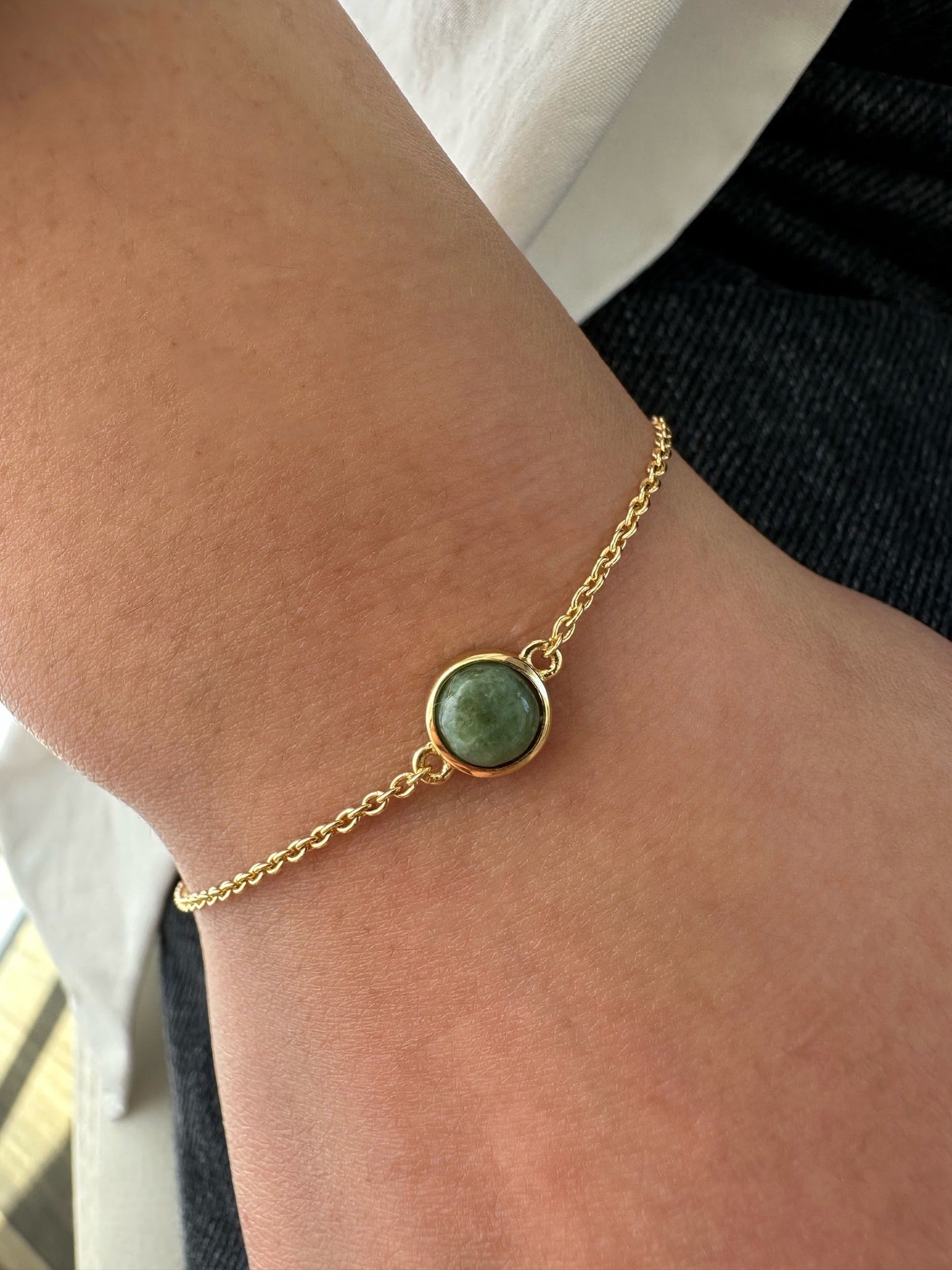 Closeup of gold jade bracelet on wrist