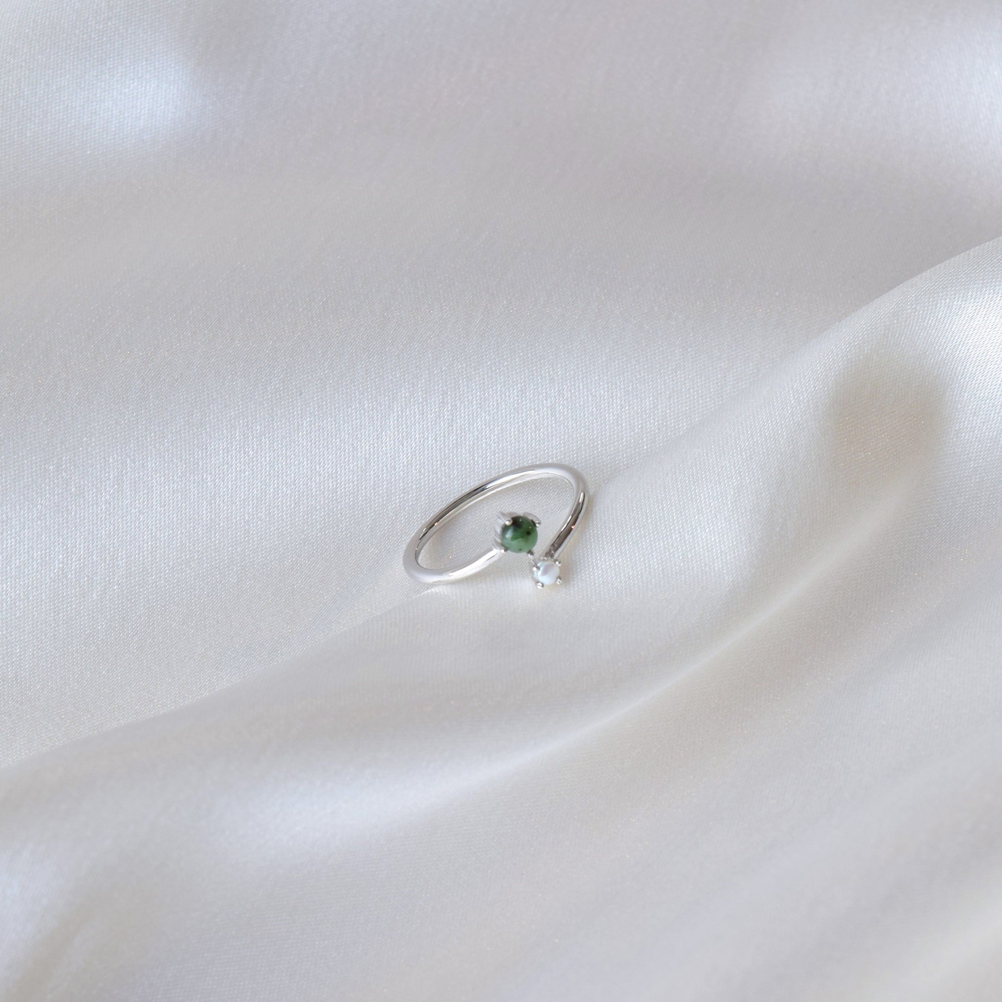 Silver jade and pearl ring on cloth