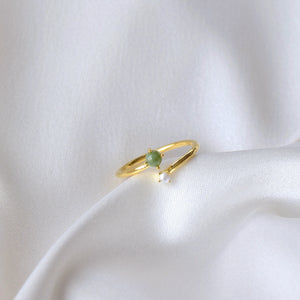 Closeup of jade and pearl ring on cloth