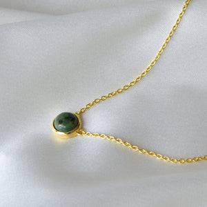 Closeup of Gold Jade Bracelet on Cloth