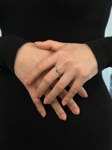 Hands crossed displaying a silver jade and pearl ring